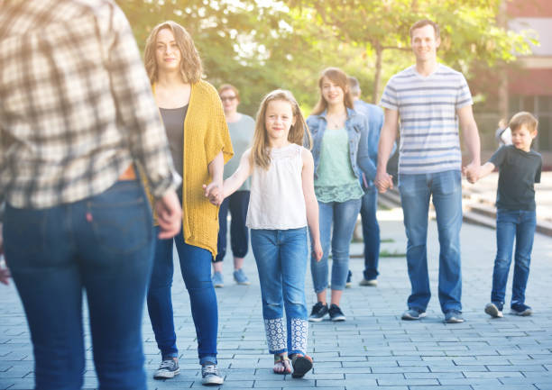istock Women and men with children walk 942658512