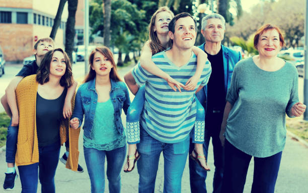 istock relatives walking in the park 942658586