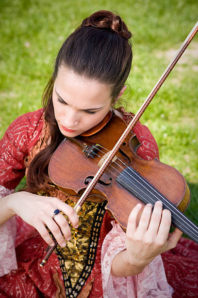 istock Young girl playing violin outdoor 94266870