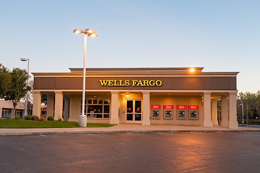 Pleasanton, California, United States - March 26, 2018:  Dusk view of Wells Fargo bank branch with brightly lit ATM machines visible in Pleasanton, California, March 26, 2018