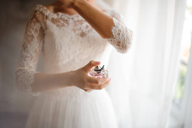 istock Bride in a beautiful white wedding dress with a perfume 942669518