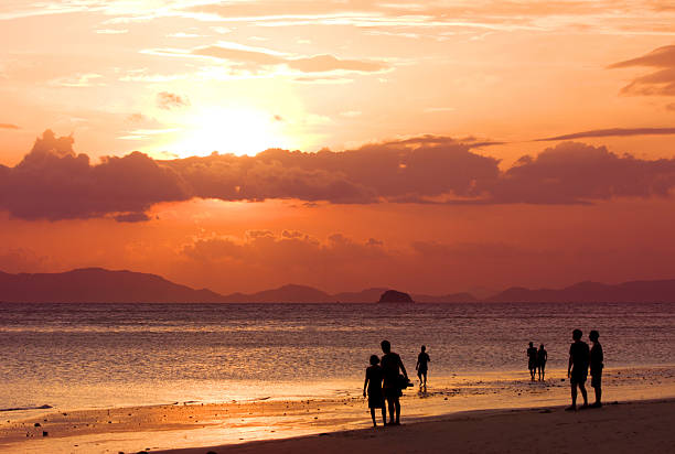 istock peoples at beach look to sunset 94266961