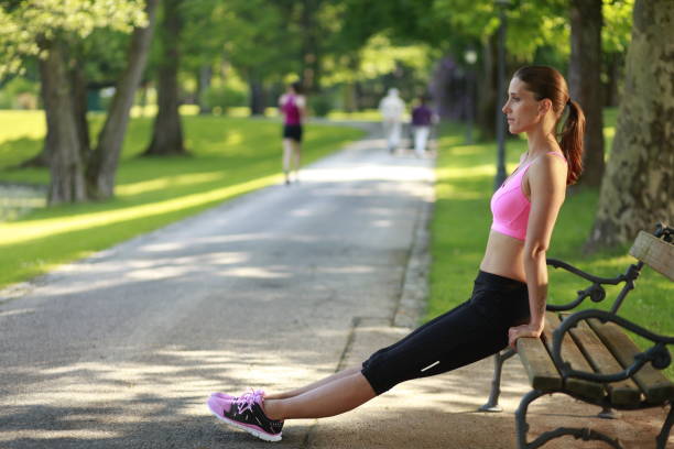 istock Female jogger stretching on a park bench 942670722