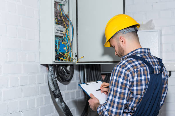 istock Professional electrician inspecting wires in electrical box 942681804