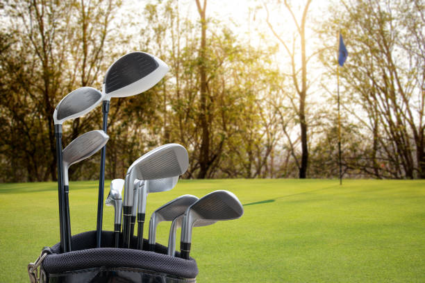 istock Golf equipment on green field background. 942681996