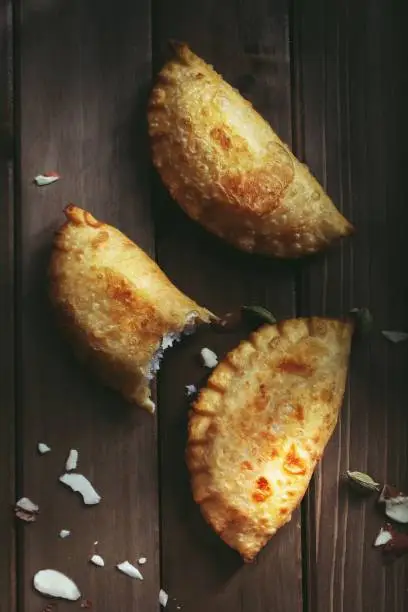 Homemade Gujiya / Karanji - Indian festival sweet on dark moody background