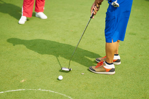 istock unrecognizable man playing golf on putting green in summer 942685538