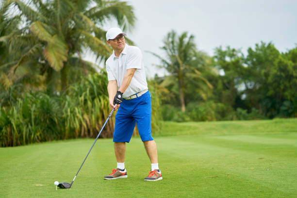istock Asian man swinging club in golf course in summer 942685792