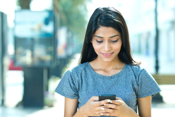 istock Beautiful woman using mobile phone 942686226