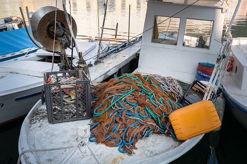 Closeup of a colorful fishing net lying on a boat, Cres Croatia