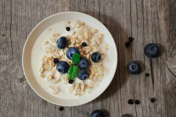 Overnight Oats with banana and blueberries overhead view / Healthy breakfast