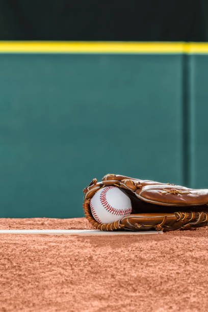 istock A new baseball in a glove on the pitcher's mound rubber 942689490