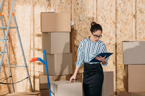 istock Businesswoman with clipboard checking delivery packages 942689812