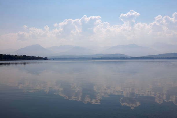 istock Waterscape of lake with cloudy sky reflection 942689854