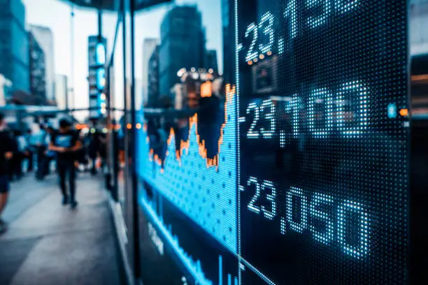 Photo of Financial stock market numbers and city light reflection