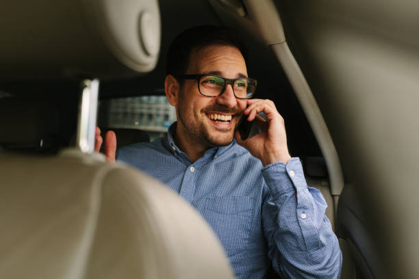 istock Businessman using mobile phone in the car 942699550