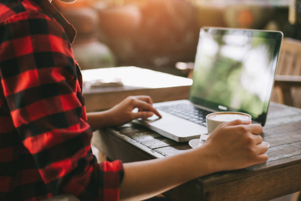 istock Woman typing on notebook computer in coffee shop 942700592