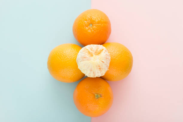 istock Fresh orange fruits on rose blue background. Directly above view. 942700968