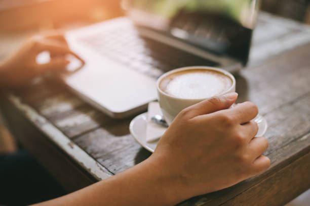 istock Woman typing on notebook computer in coffee shop 942700974