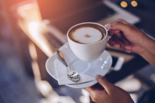 istock Woman holding warm mug with fresh coffee 942703564
