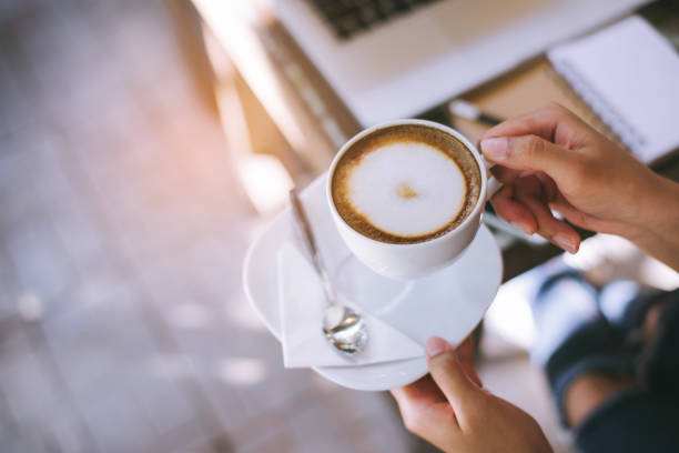 istock Woman holding warm mug with fresh coffee 942703728