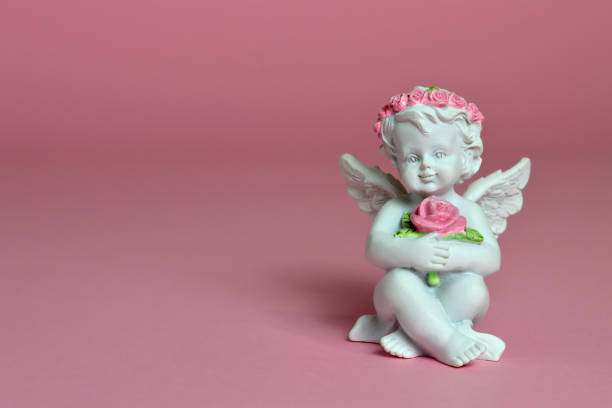 istock Angel figurine on pink background 942706980