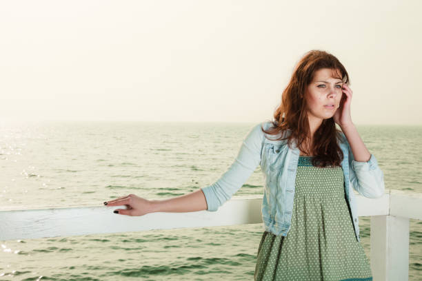 istock Young woman relaxing on pier outdoor 942707732