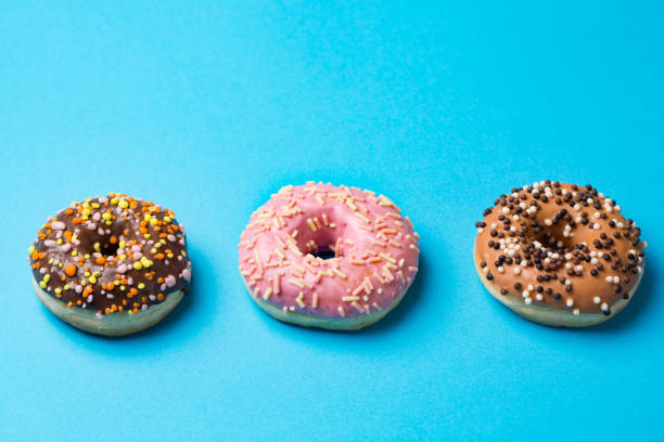 istock top view of three donuts on blue background with copyspace 942708786
