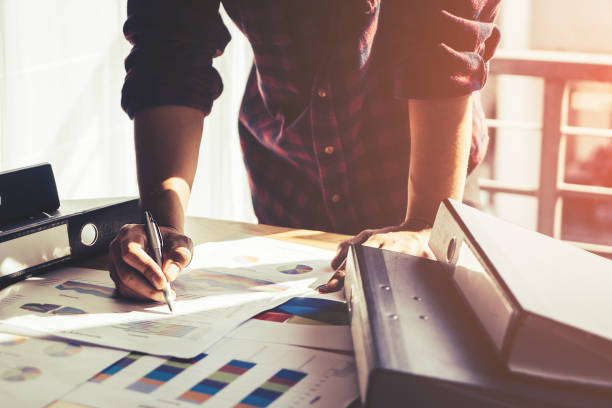 istock Casual business man writing on businss report 942709316