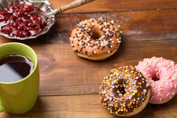 istock Dougnut filled with crimson jam and cold coffee - Hanukkah 942711532