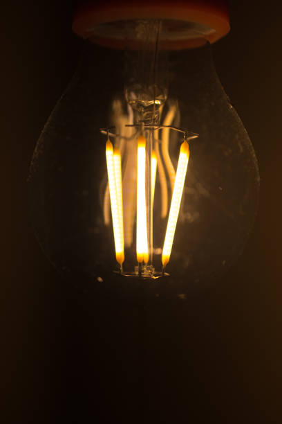 istock Light bulb is glowing in the dark. Retro background with copy space. 942713320