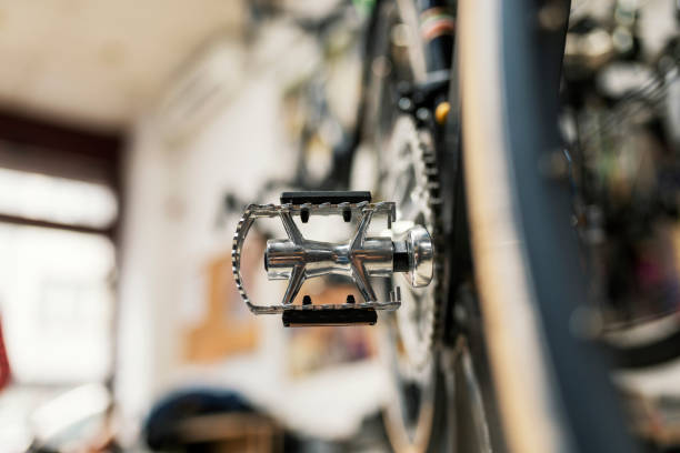 Racing bike detail Bike service, pedal maintenance. Photo of Bike close up on gear wheel, pedal and wheel in the sunny garage or workshop. bike workshop stock pictures, royalty-free photos & images