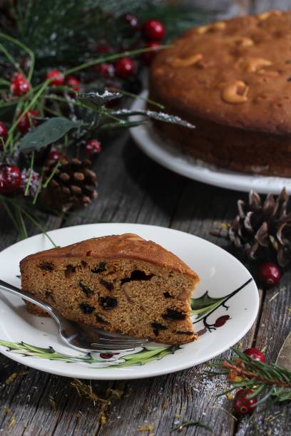 istock Slice of Homemade Xmas fruit cake on festive background, selective focus 942715942