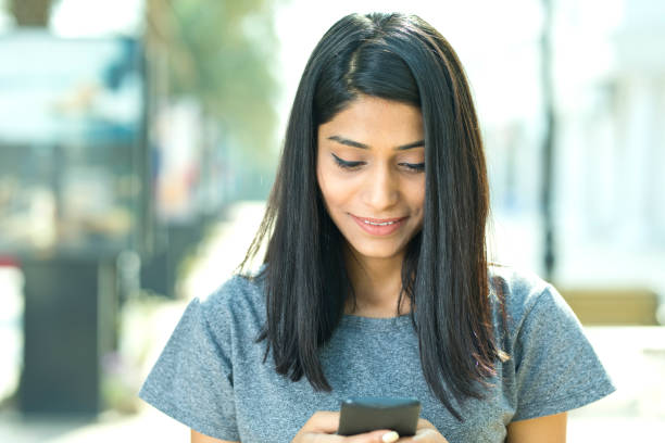 istock Beautiful woman using mobile phone 942717084