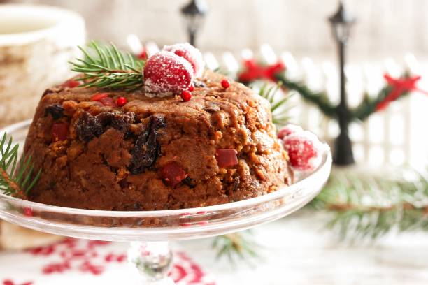 istock Homemade Xmas Pudding cake on white holiday background, selective focus 942717716