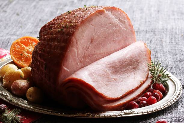 istock Roasted Ham with thyme baked potatoes and cranberries / Xmas Dinner Concept 942717746