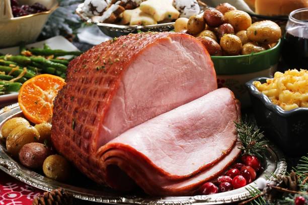 istock Holiday baked Ham with sides  / Xmas Dinner  table setting, selective focus 942717878