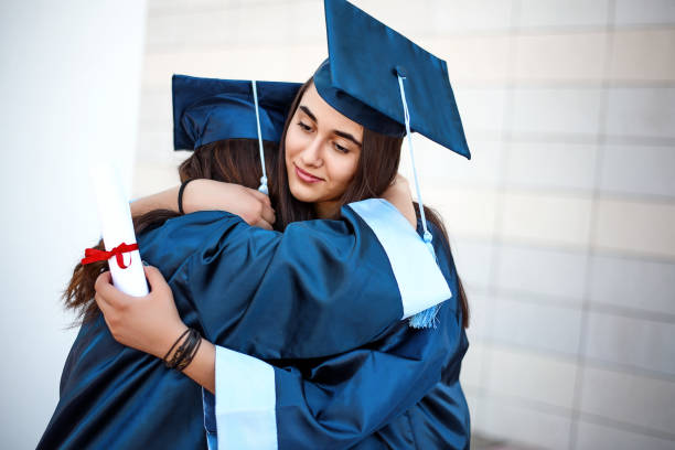istock Two unhappy girlfriends left after graduation 942721132