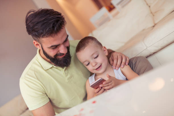 istock Father and son playing at home 942724368