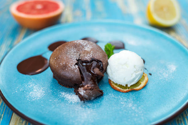 istock chocolate cake with a white ice cream ball on a blue plate 942728076
