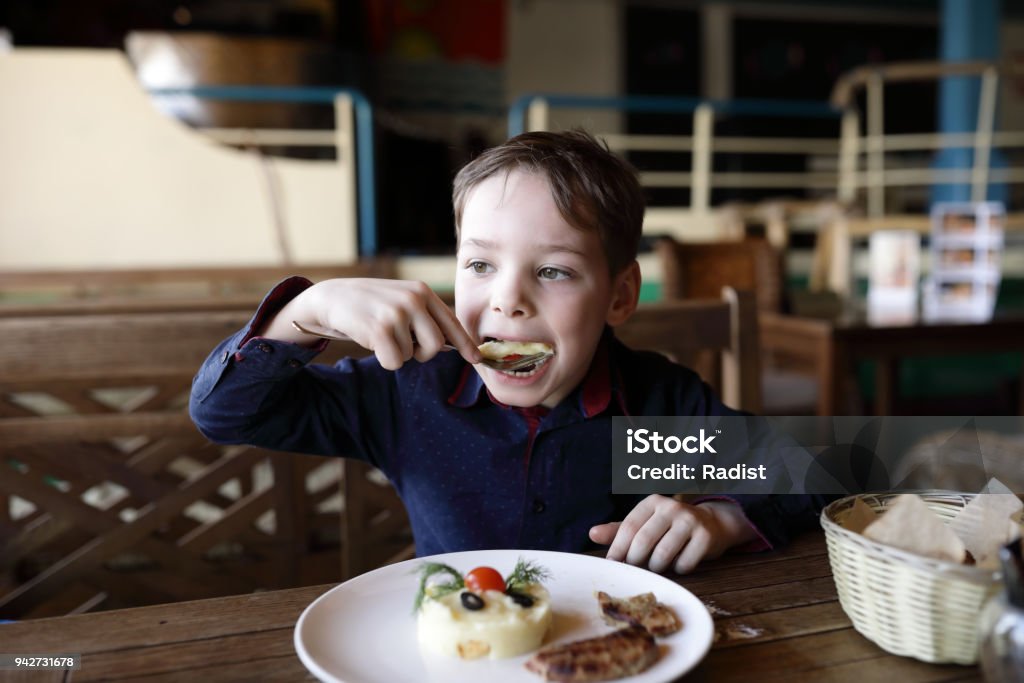 Child has mashed potatoes Child has mashed potatoes in a cafe Boys Stock Photo