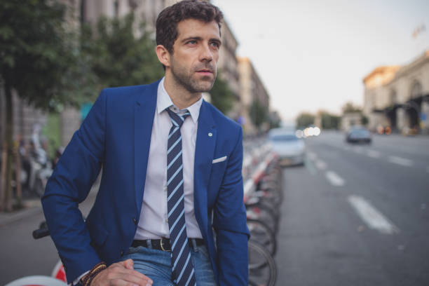 istock Businessman sitting near bicycle sharing system 942739536