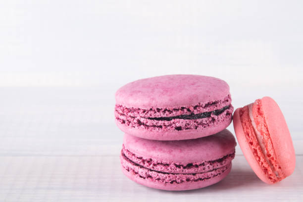 istock 3 multicolored macaron cookies, on grey background 942739538