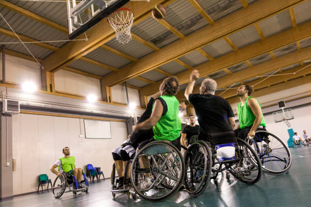 istock disabled sport men in action playing basketball 942740982