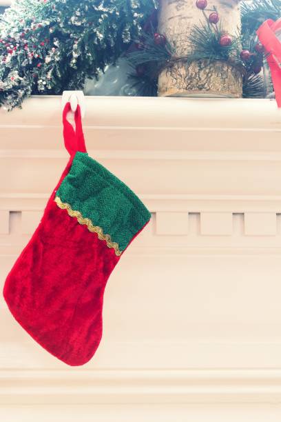 istock Xmas stocking hanging on a fireplace / Christmas frame 942743222