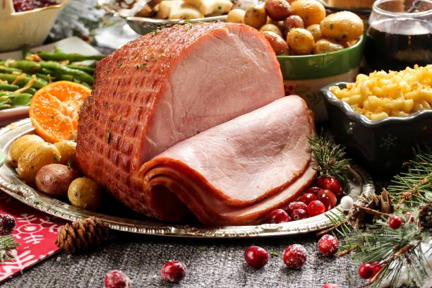 Holiday baked Ham with sides / Xmas Dinner table setting, selective focus Holiday baked Ham with sides green beans,roasted potatoes, mac and cheese ,cookies and pumpkin pie / Xmas Dinner table setting, selective focus christmas bacon stock pictures, royalty-free photos & images