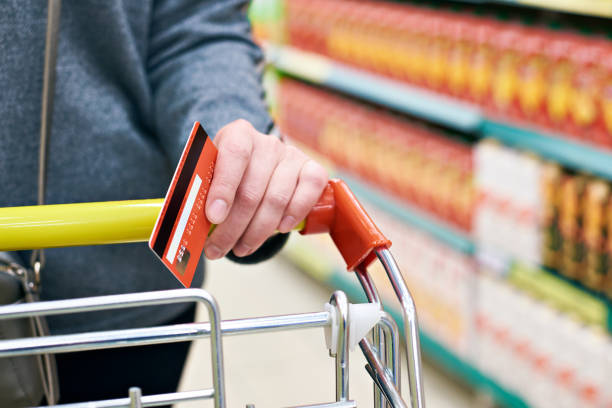 istock Bank card in hand at store 942747912