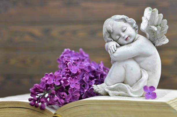 istock Condolence card with guardian angel and spring flower 942748520