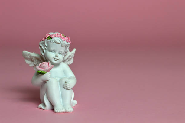 istock Guardian angel holding flowers 942748664