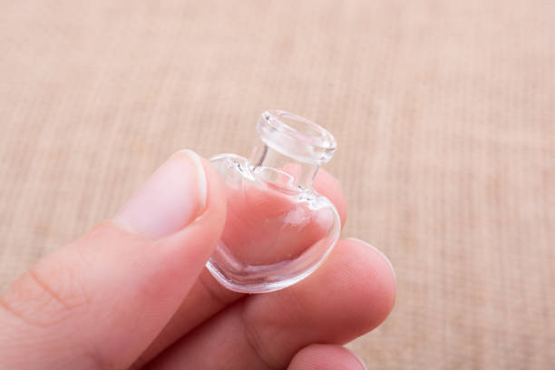 istock Heart shaped glass bottle in hand 942751580